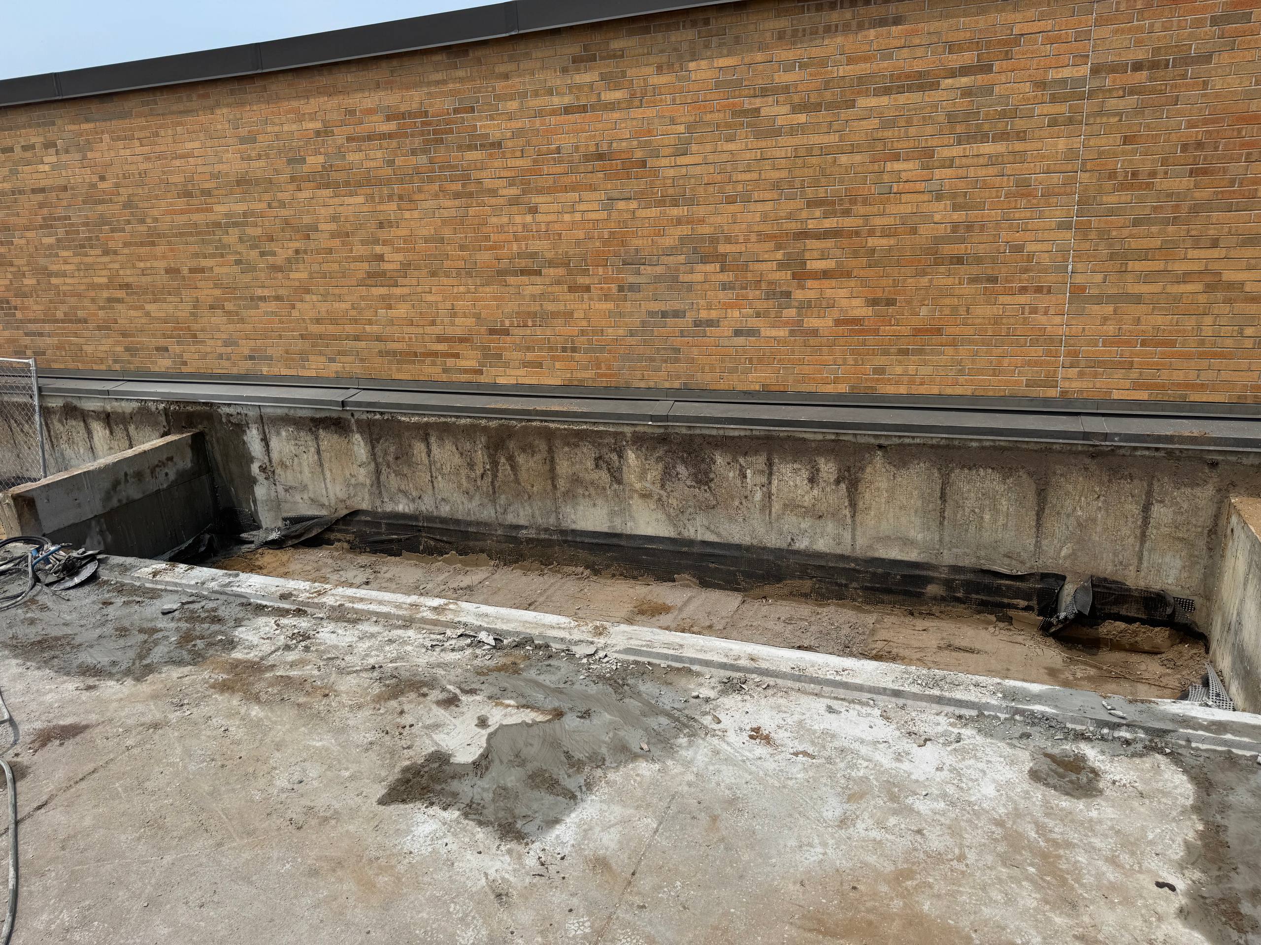 Long concrete wall section removed at commercial construction site