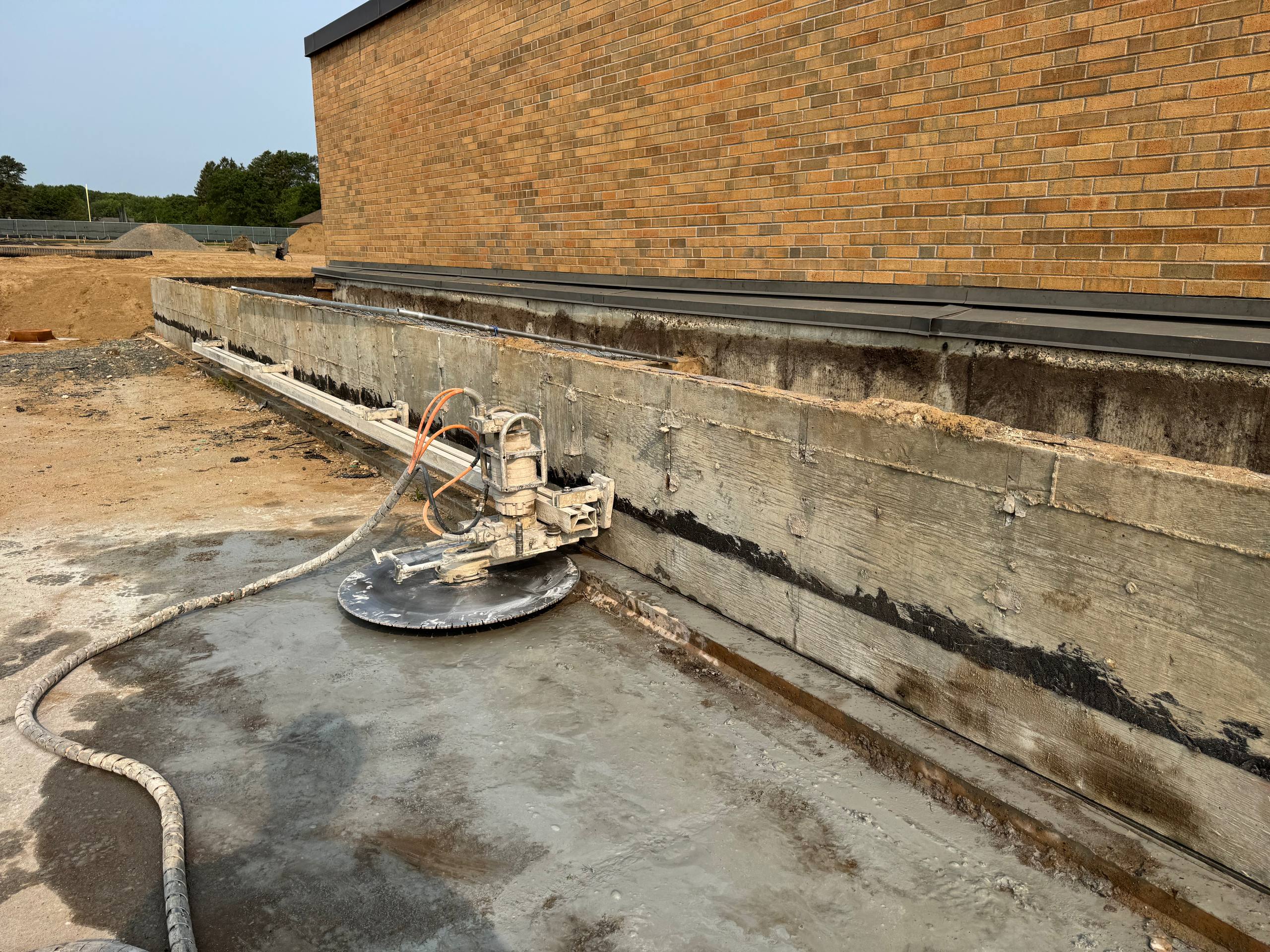 Wall saw equipment cutting concrete at commercial building renovation