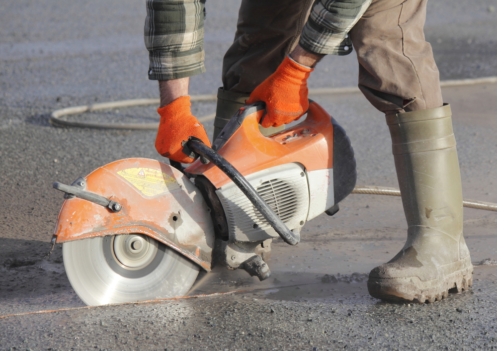 Emergency concrete cutting with handheld diamond saw for urgent repair access